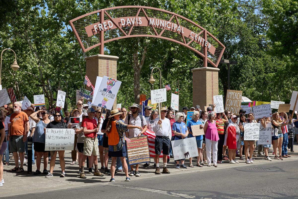 Citizens of Chico line the streets near Fred David Municipal Center during the No Kings protest in Chico, California, on the morning of June 14, 2025