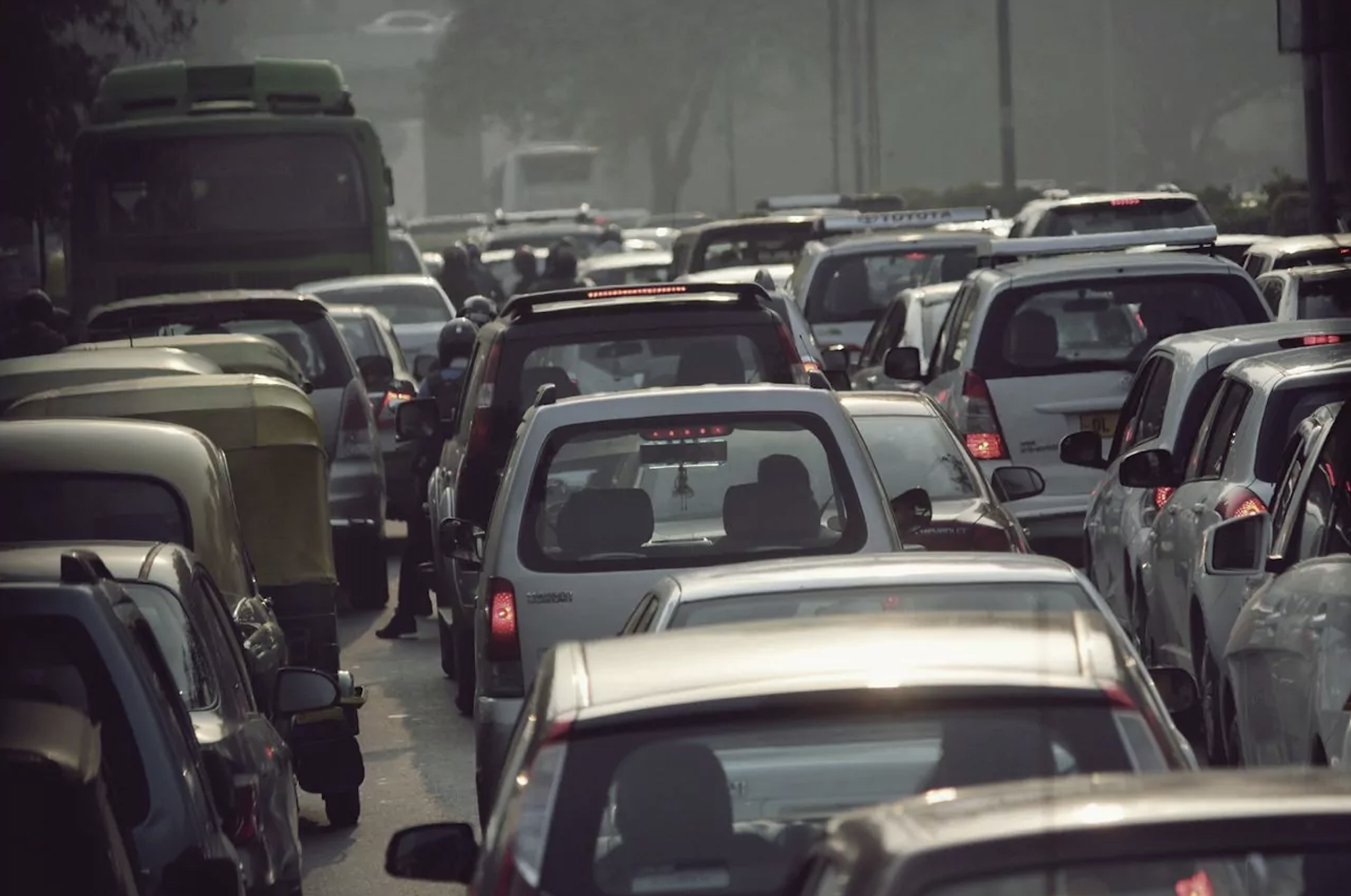 View from behind a sea of cars, as if viewer was also stuck in a car in traffic.