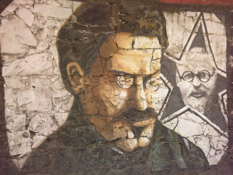 Mural of Trotsky on a wall. The paint is cracked.