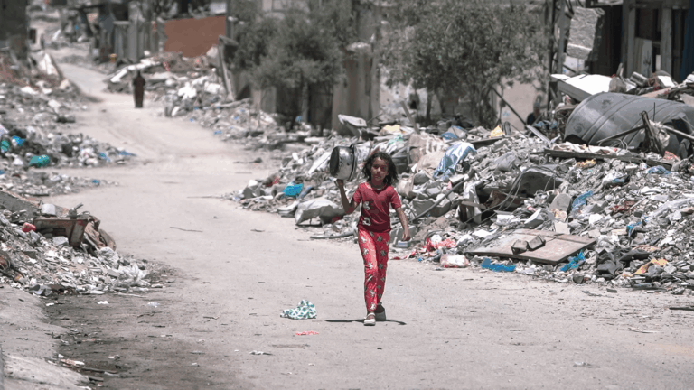 A girl walks inside Gaza to get food.