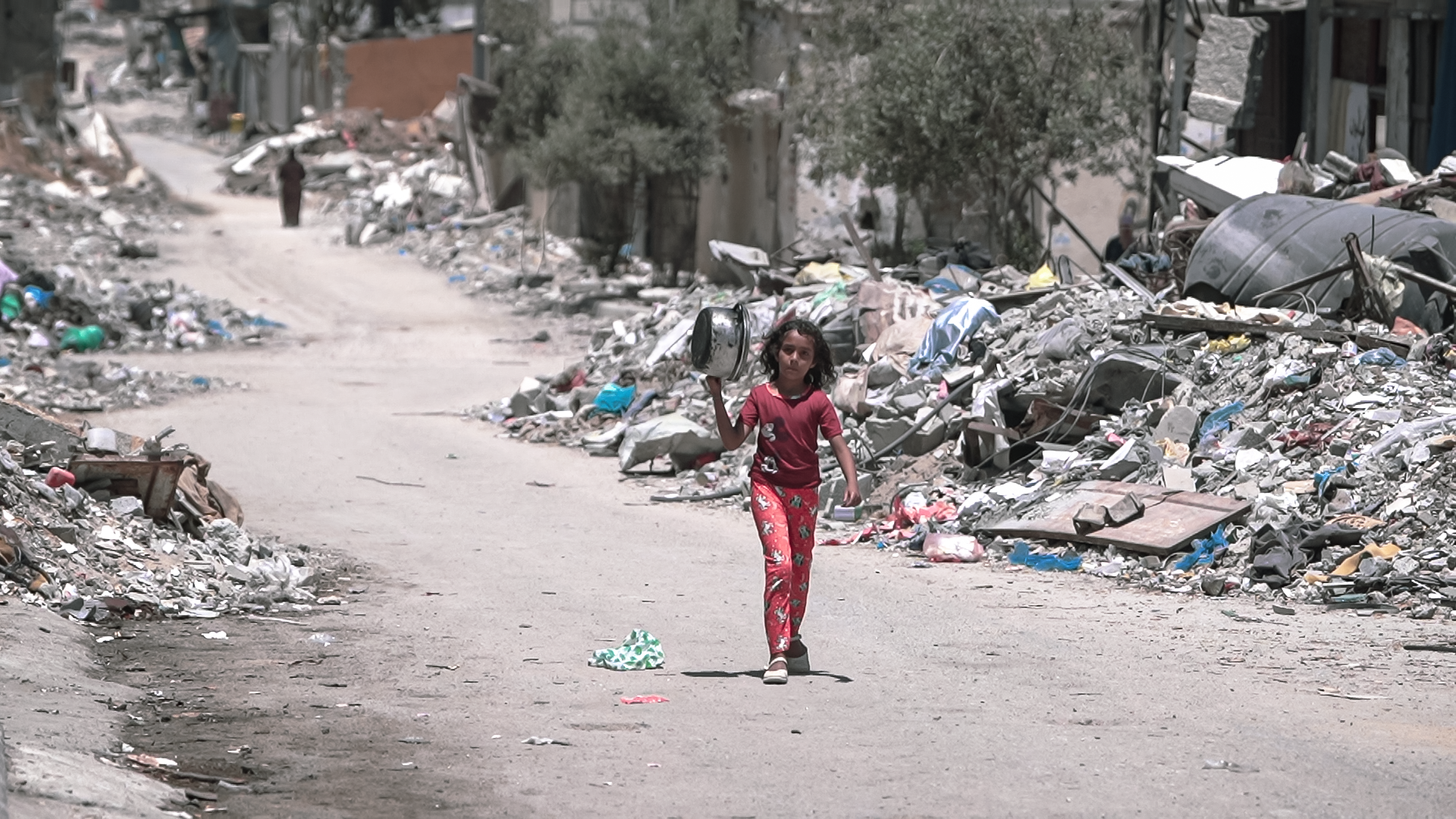 A girl walks inside Gaza to get food.
