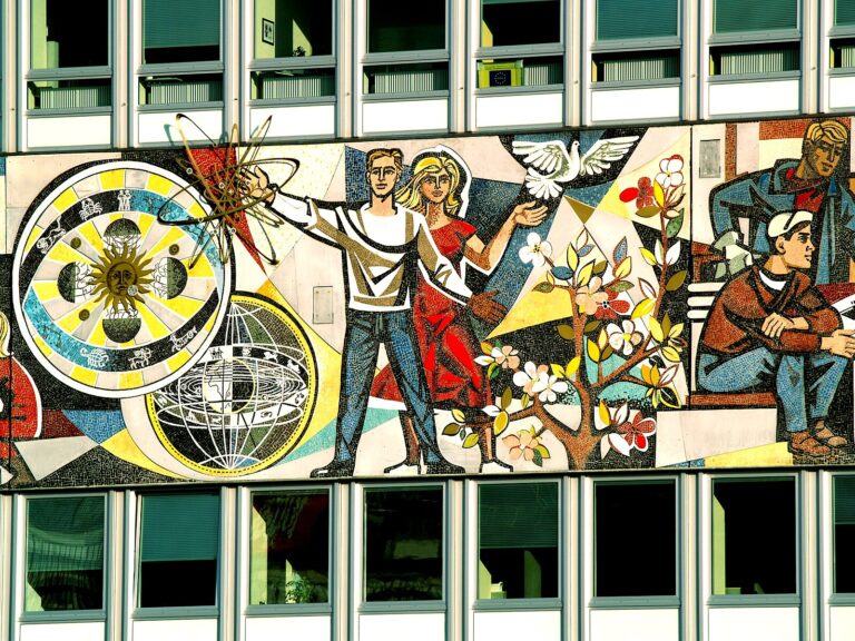 A mural depicting a socialist utopia: two smiling people with symbols of science and advancement swirling around them.