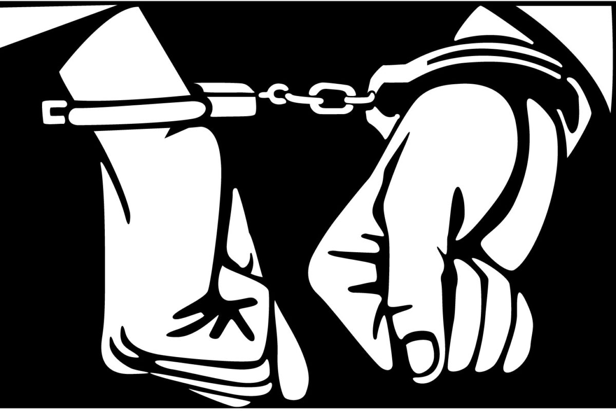 Hands in handcuffs, black and white