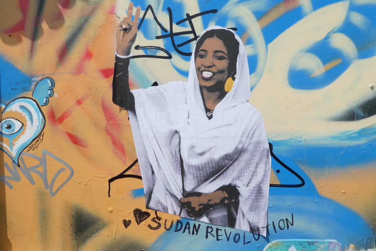 A photograph of a street mural depicting Alaa Salah, whose image became a widespread symbol of the Sudanese revolution.