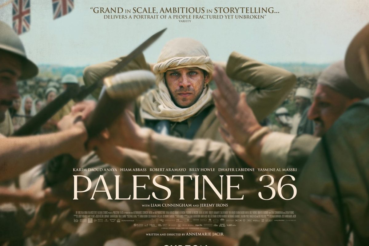 Movie poster for Palestine 36. A man surrounded by fighting stands, adjusting the white cloth around his head and stares straight ahead.