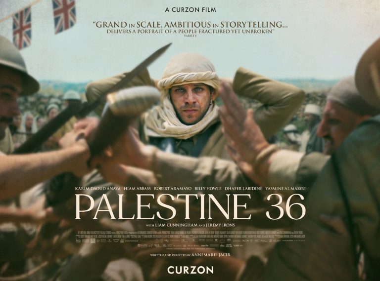 Movie poster for Palestine 36. A man surrounded by fighting stands, adjusting the white cloth around his head and stares straight ahead.